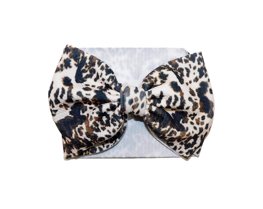 Brown small spots cowhide bow