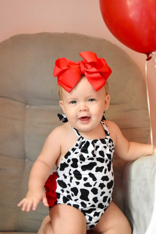 Cow print tie romper with red ruffles